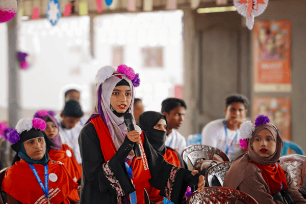 Person speaking into microphone