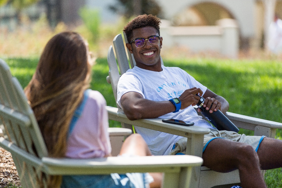 two kroc students sitting and laughing